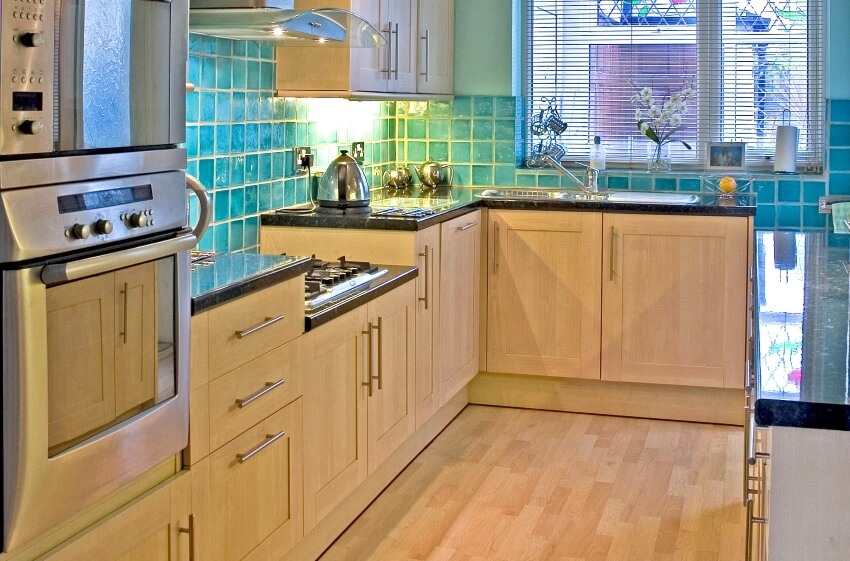 Small kitchen with aqua blue tile backsplash and shaker birch cabinets