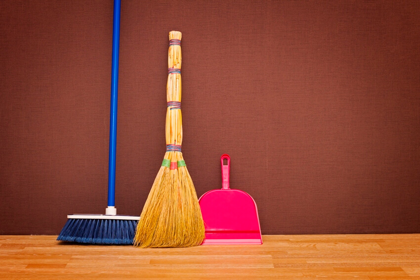 A soft and hard broom and a dustpan