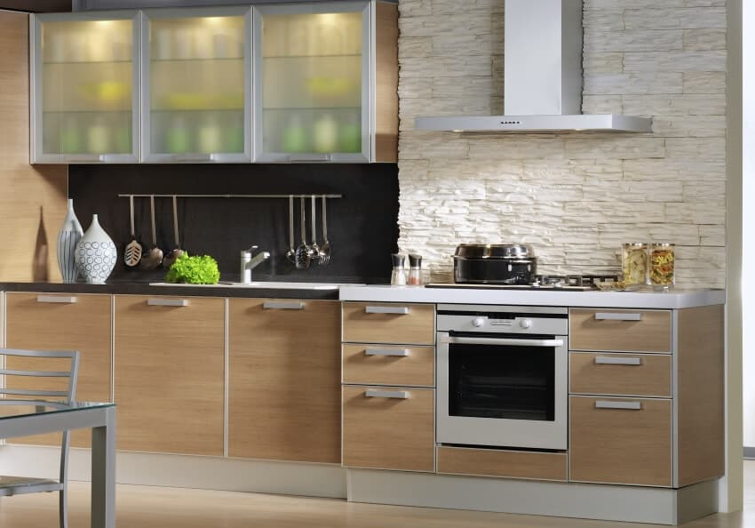 Spacious kitchen with stone backsplash and aluminum cabinets