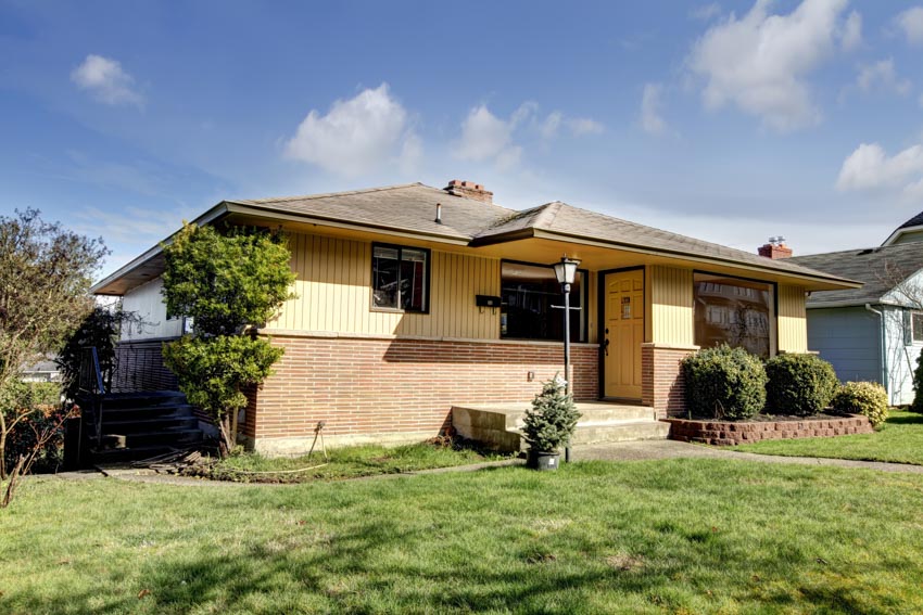 Split-level home with brick wall cladding, and door