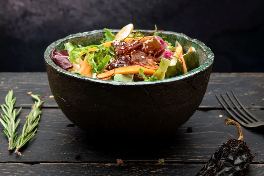 Stoneware bowl with salad in it