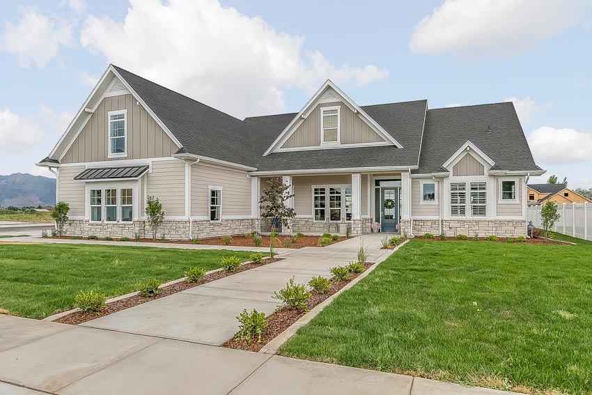 Traditional rambler style home with dormer and roof shingles