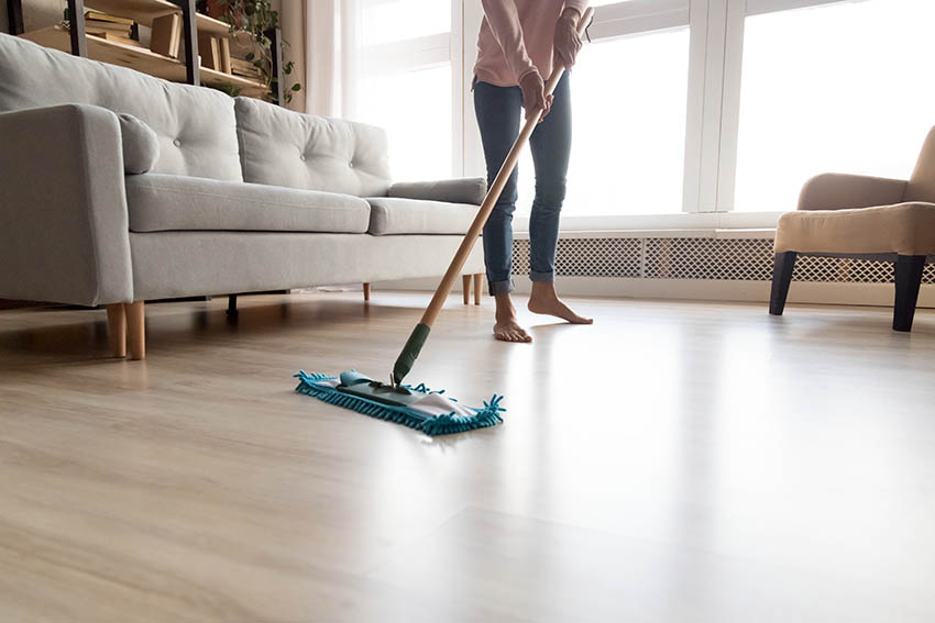 Using mop to clean wood flooring
