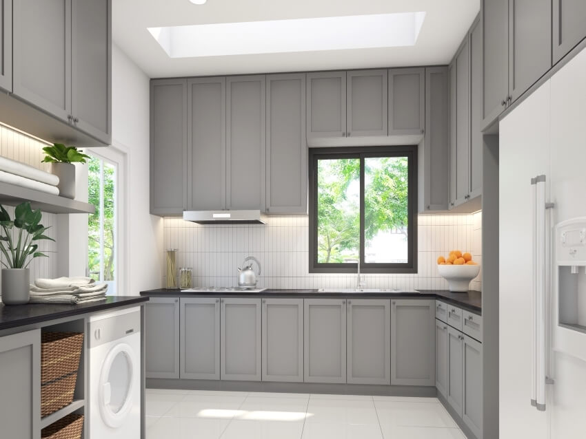 White and gray kitchen with subway tile backsplash and panel cabinets