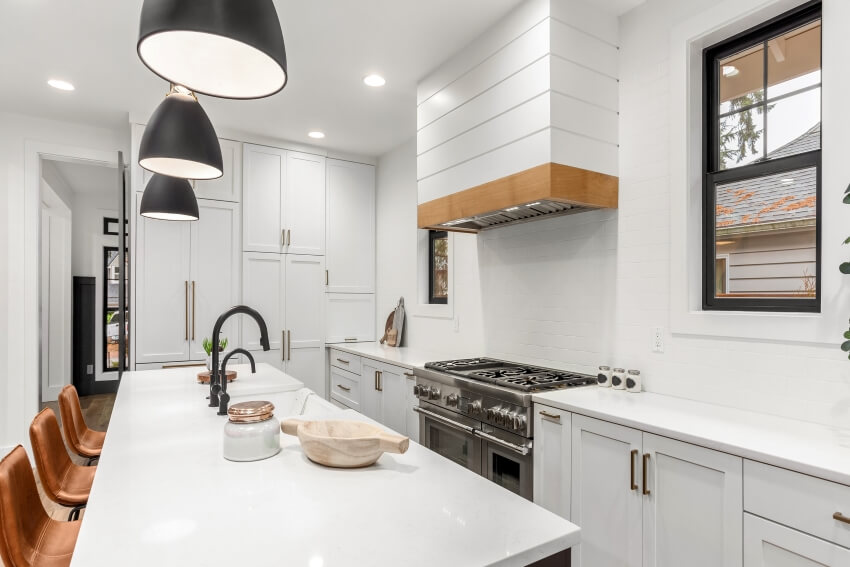 White kitchen with dark accents DIY nickel gap shiplap and large island in farmhouse style home