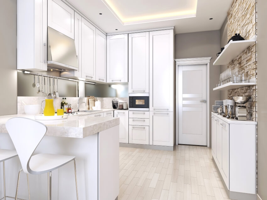 White kitchen with stone accent wall and floating shelves