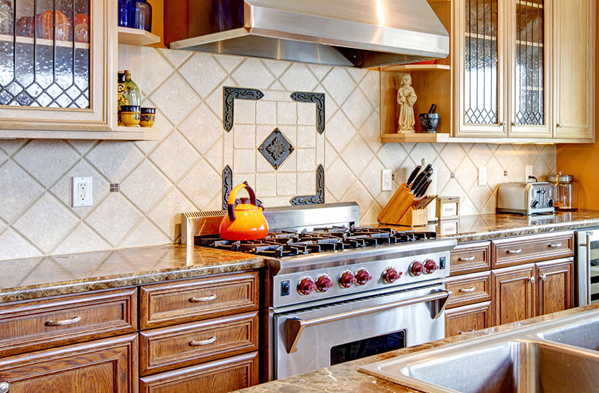 Mediterranean style kitchen with big stove stainless rangehood natural wood finish cabinets diagonal backsplash