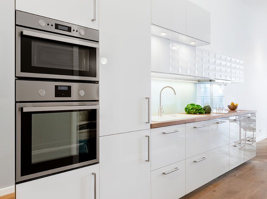 White kitchen with microwave drawer glossy finish cabinets
