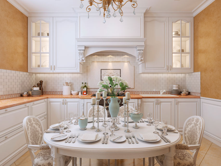 Authentic victorian kitchen with countertop, glass cabinets, table, chairs, and centerpiece