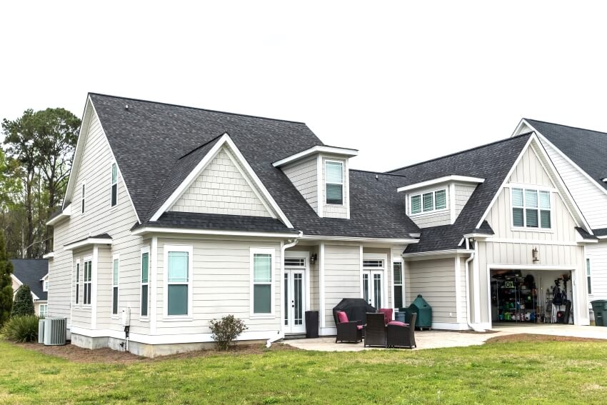 Gray roofing with white siding and dormers