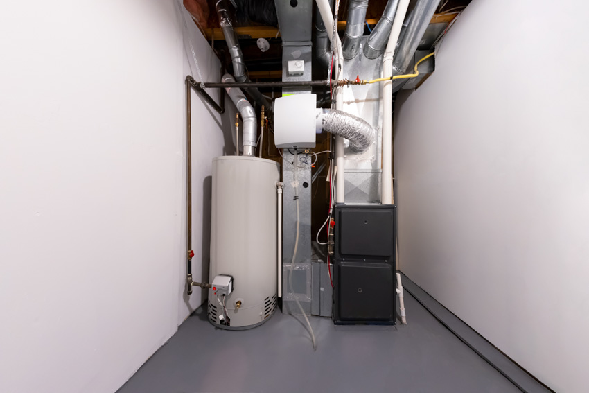 Basement with single stage furnace, boiler, epoxy flooring, and white walls