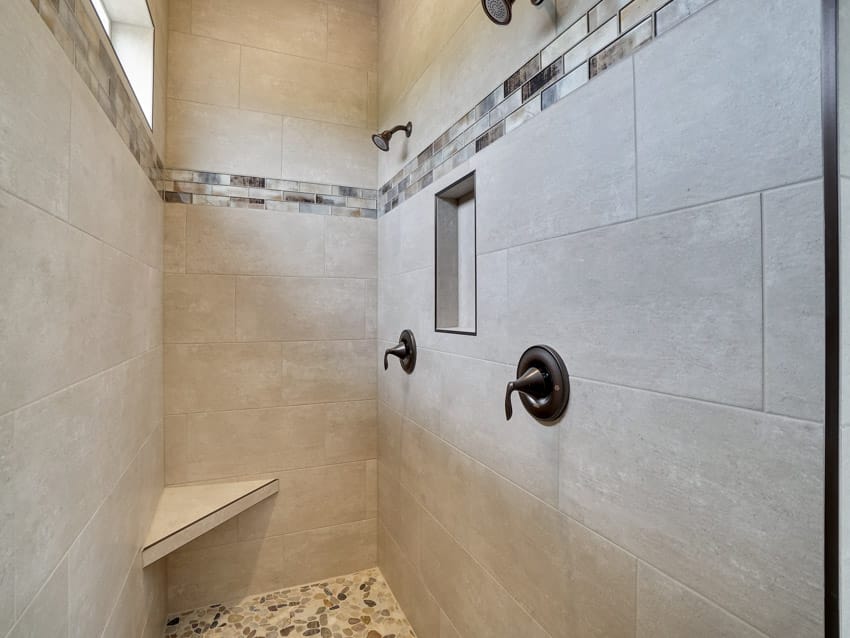 Bathroom shower with listello tile, fixtures, and window