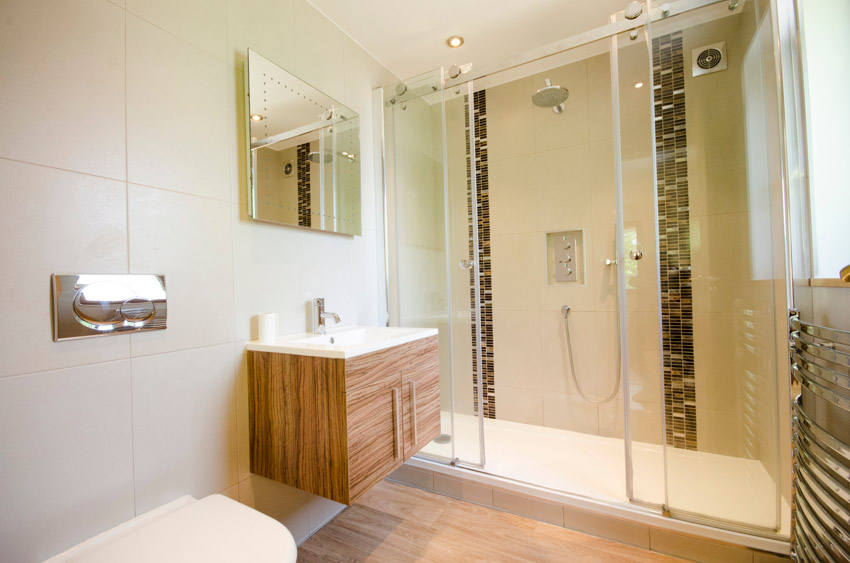 Bathroom with floating vanity, waterfall vertical tile installed in shower, countertop, mirror, and sink