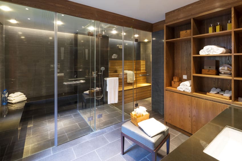 Bathroom with walk-in-shower sauna, countertop, ceiling light, and tile floors