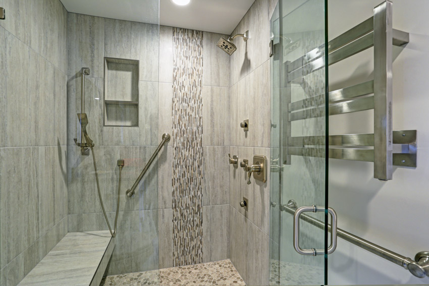 Bathroom with glass tile vertical placement shower, shower head, and glass swinging door