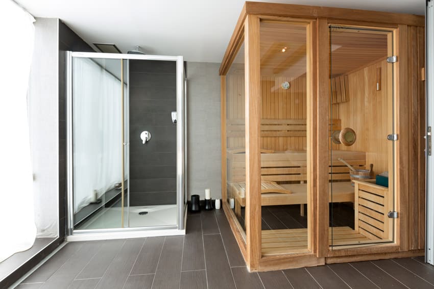 Bathroom with infrared sauna, shower enclosure, window, and tile flooring