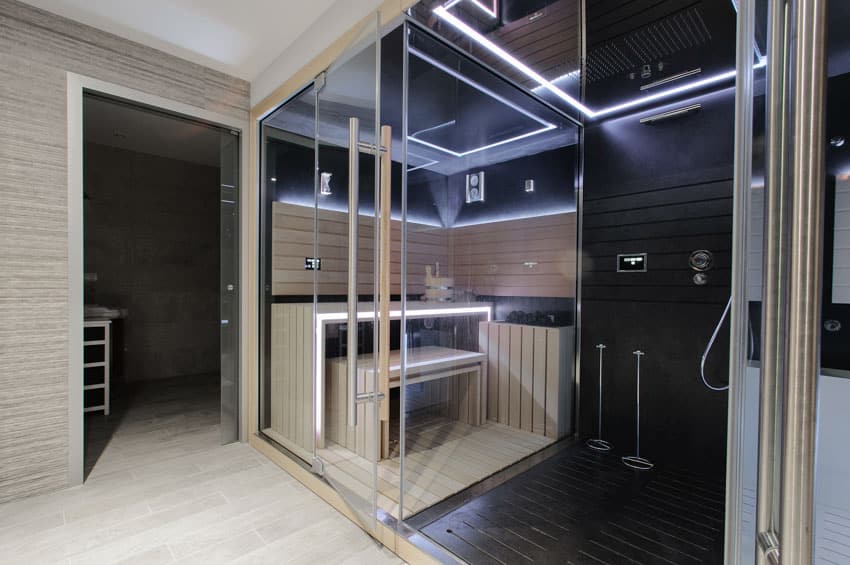 Bathroom with sauna, shower, glass enclosure, showerhead, and wood floors