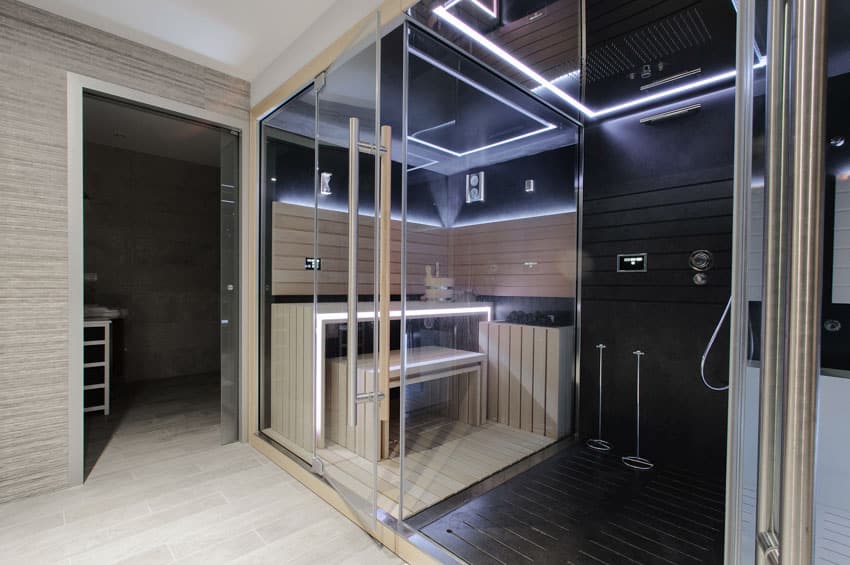 Bathroom with glass enclosure, showerhead, and recessed lighting