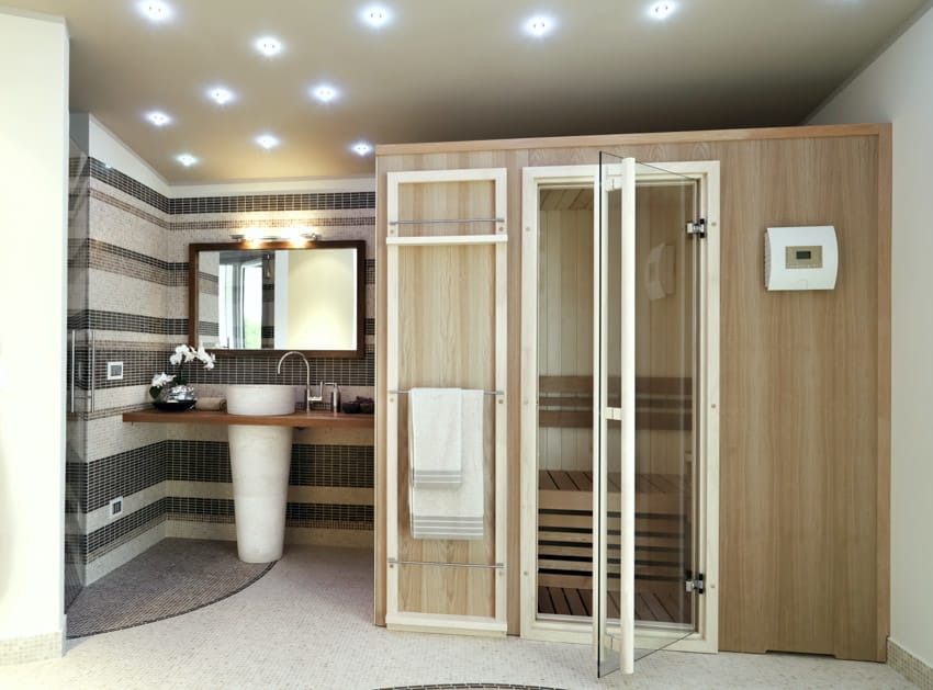 Spacious bathroom with sauna, tub, shower, and backlit lights