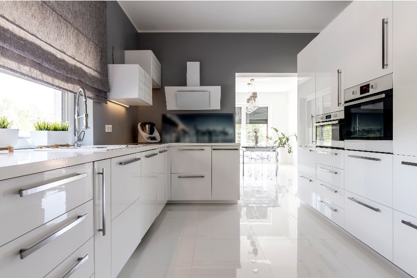 Beautiful white kitchen with gray walls, natural lighting and pvc kitchen cabinets