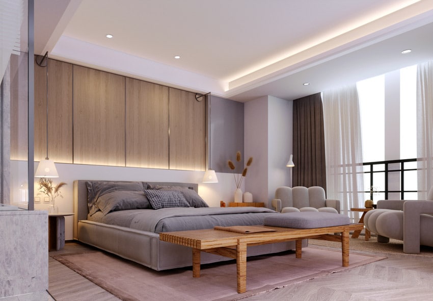 Bedroom with accent lighting, wood bench and couches