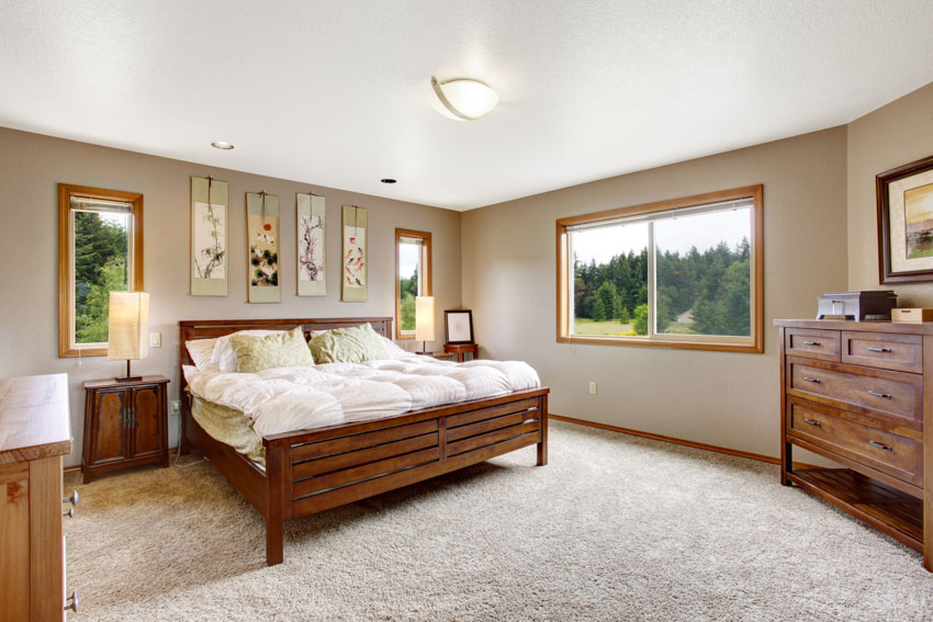 Bedroom with carpet flooring, mattress, window, mindi wood bed frame, dresser, and nightstand