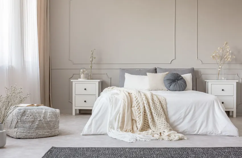 Bedroom with romantic colors, pillows, nightstands, bedding, rug, and window curtains