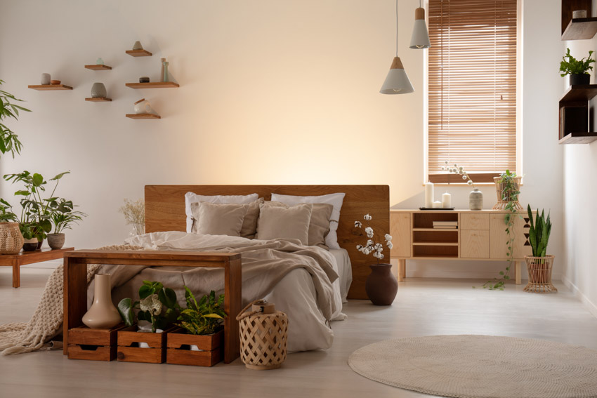 Boho bedroom with mindi wood headboard, console table, floating shelves, pendant lights, and window