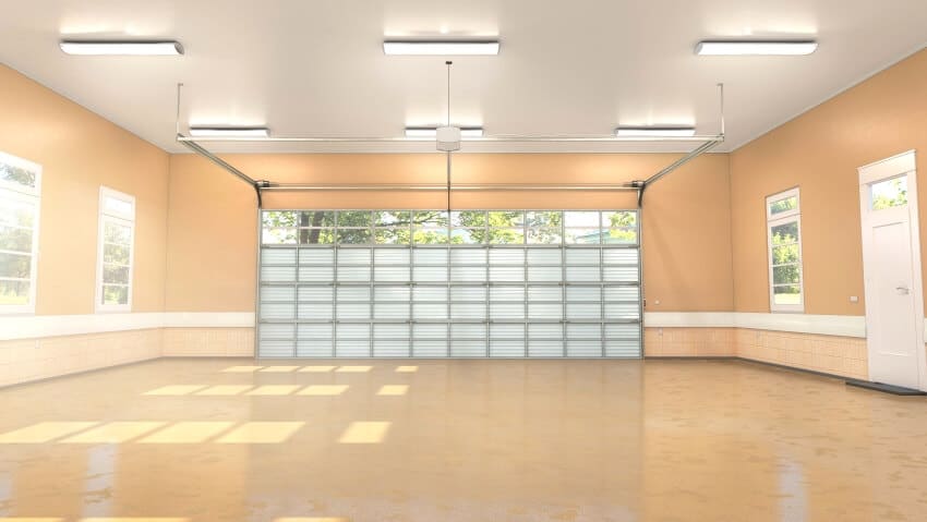 Bright garage interior with yellow walls, windows, and lighting fixtures