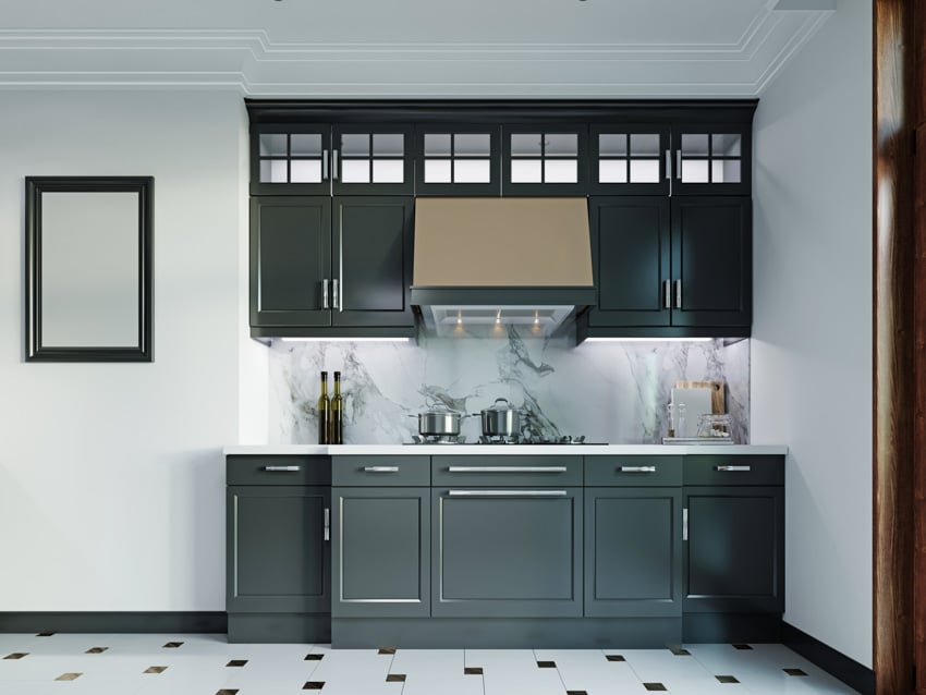 Contemporary kitchen with range hood, black cabinets, marble slab backsplash, tile flooring, and white walls