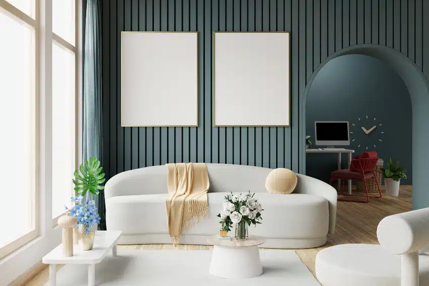 Dark green walls, wooden floors, white sofa and armchair