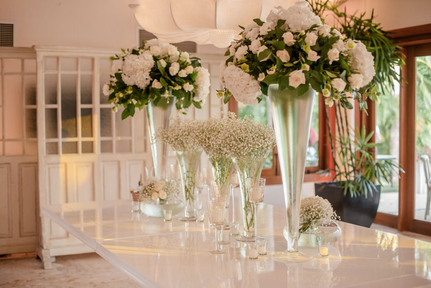 Dining table with trumpet vases and flowers