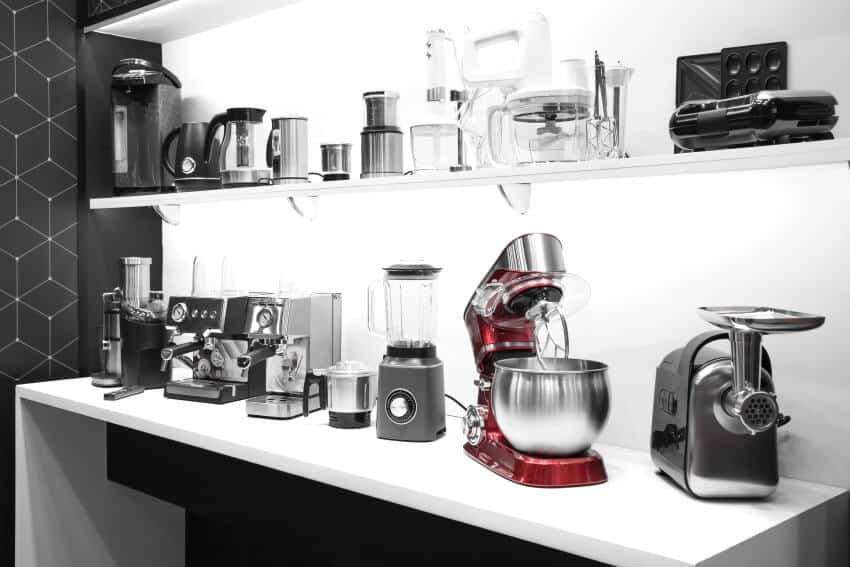 Essential kitchen appliances on a shelf and countertops in the kitchen