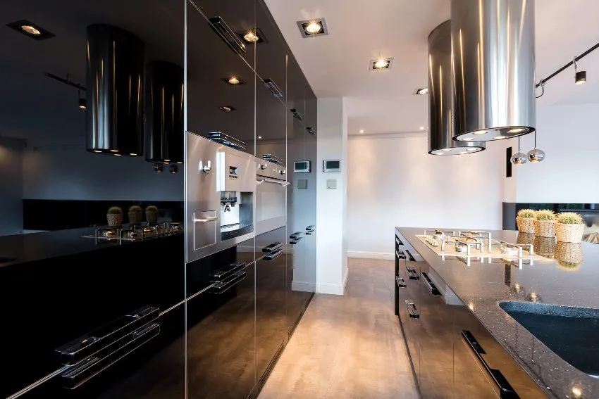 Black cabinets with acrylic finish, can lights and solid surface countertop