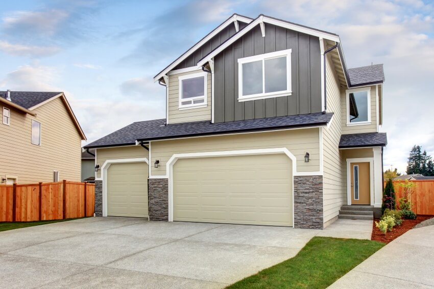 House with vertical slat siding and wood fence