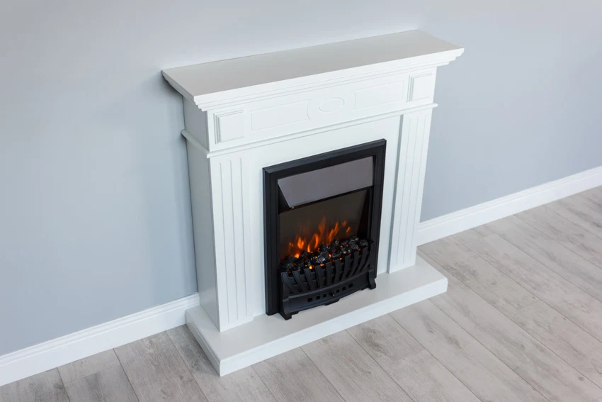 Fireplace with white mantel, beech floors and white trim