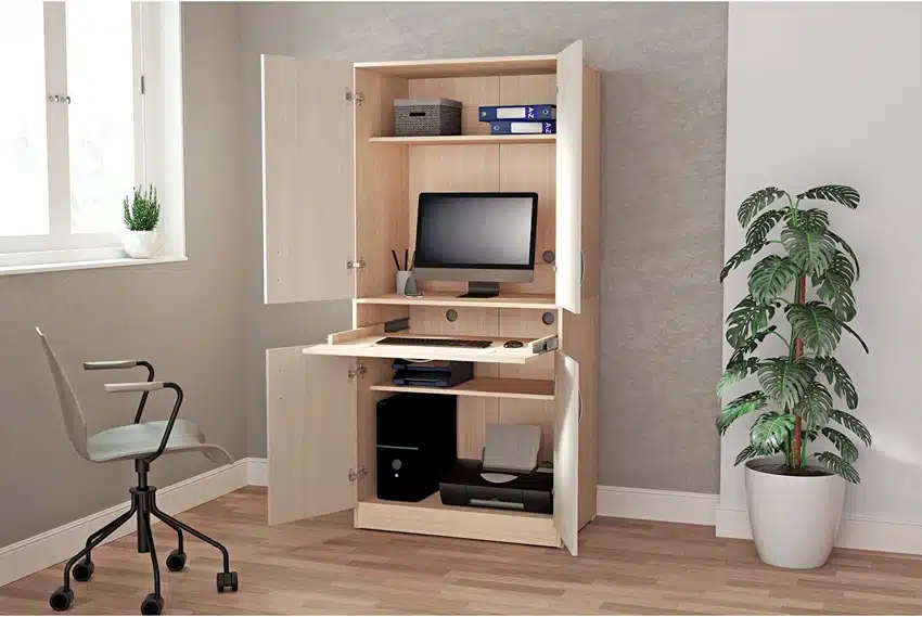 Home office with wood flooring, chair, indoor plant, window, and computer armoire