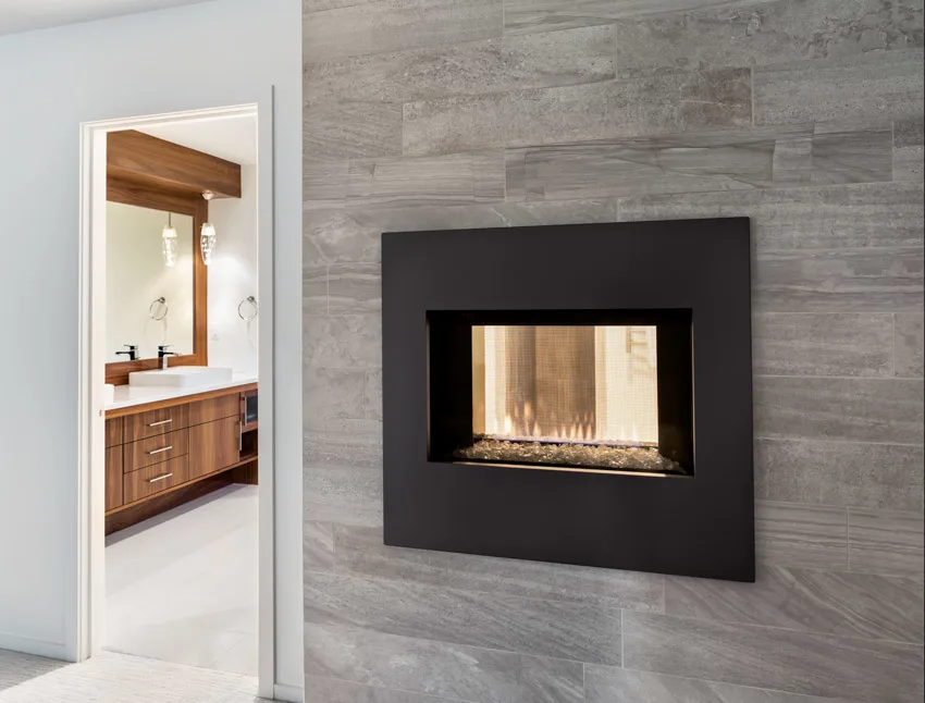 Houose with wall-mounted fireplace, white ceramic tiles and wood vanity