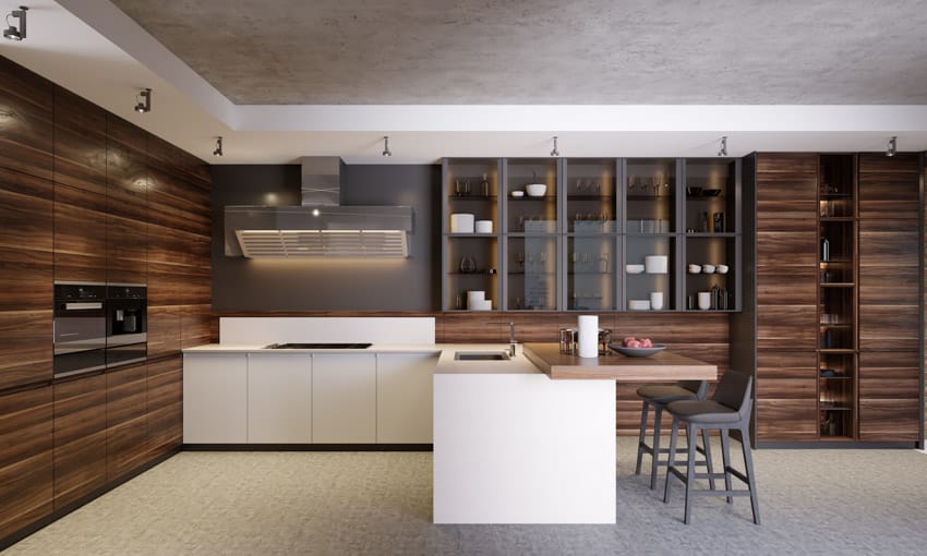 Cabinets with black glazed doors, white countertops and grey breakfast chairs