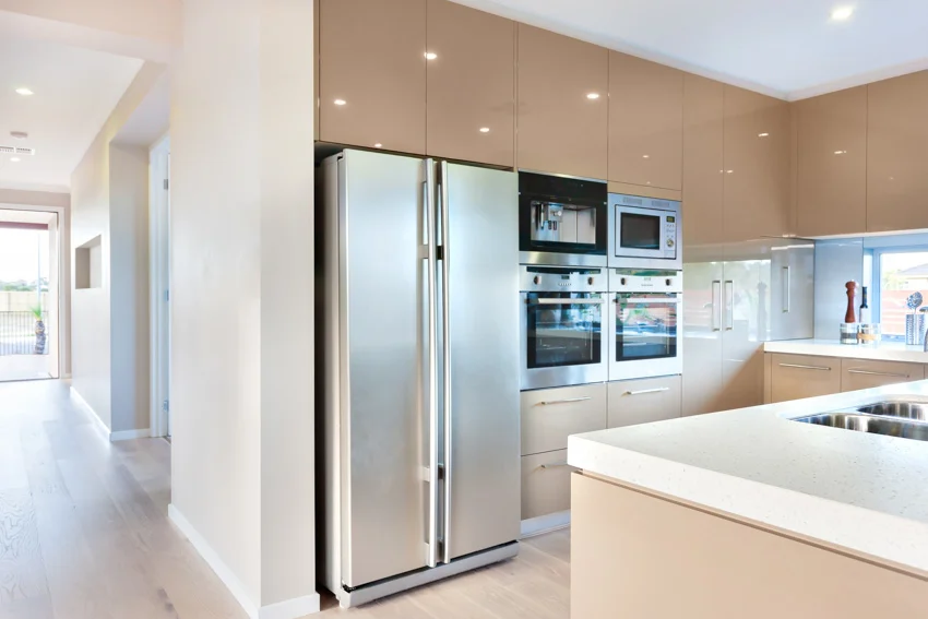 Kitchen with cabinets, oven, countertop, and refrigerator