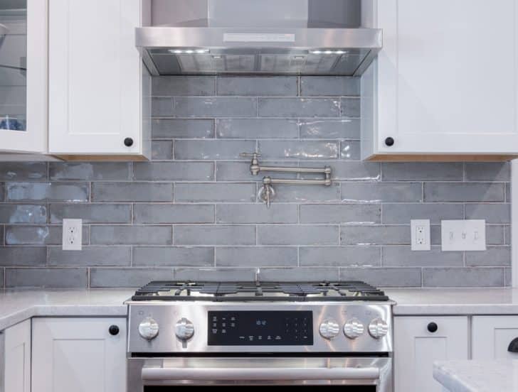 Kitchen With Cabinets Stove And Glass Tile Backsplash Is 728x552 