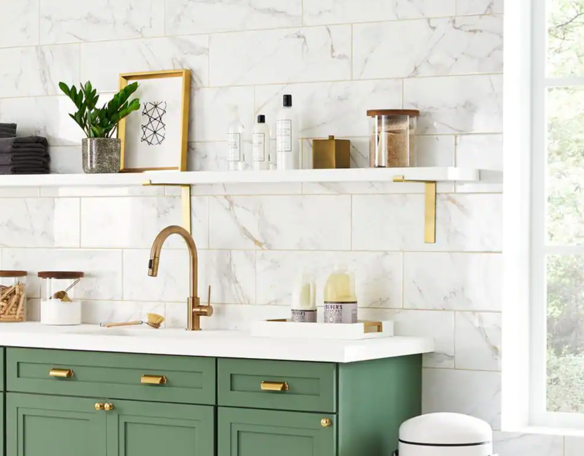 Kitchen with countertop, green cabinets, faucet, shelves, and Calcatta gold subway tile backsplash