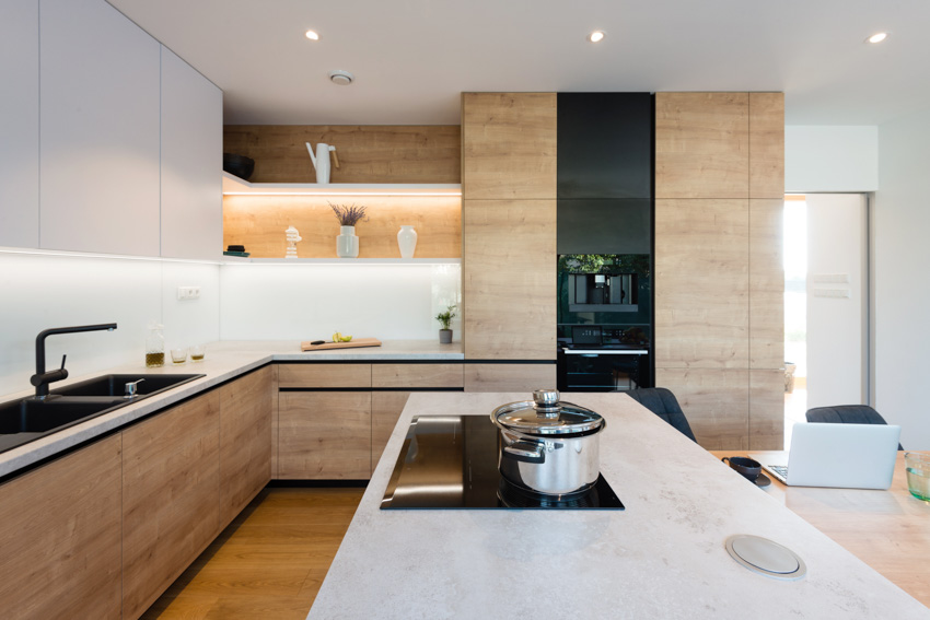 Kitchen with countertop, sink, faucet, ceiling lights, stove, shelves, and wood veneer cabinets