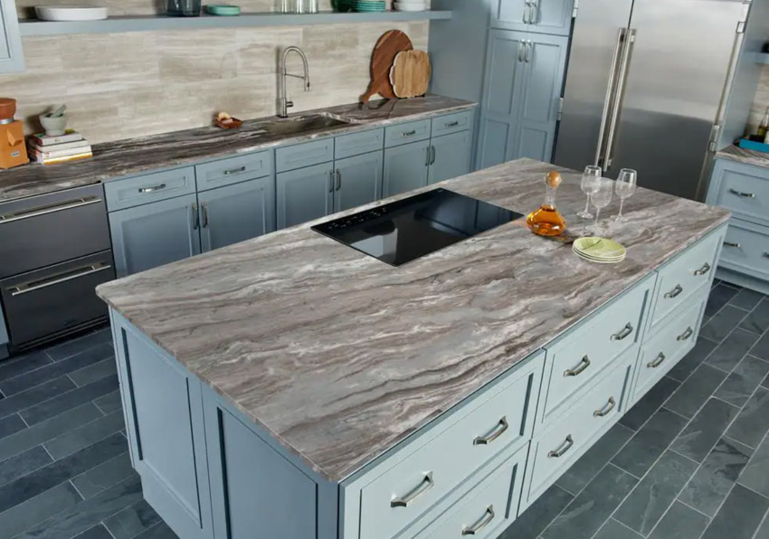 Marble countertop, wood island and tile flooring