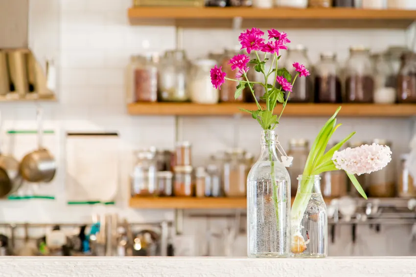 Kitchen with floating shelves and bottle vases