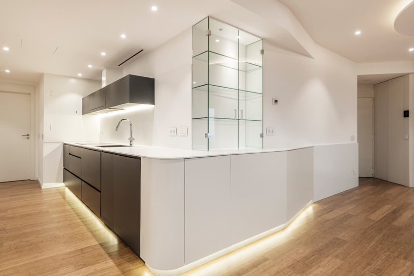 Kitchen with frameless cabinets, wood flooring and white walls