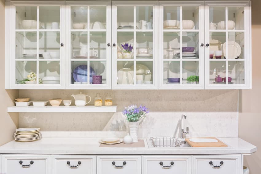 White cabinets, countertops, floating shelf and drawers
