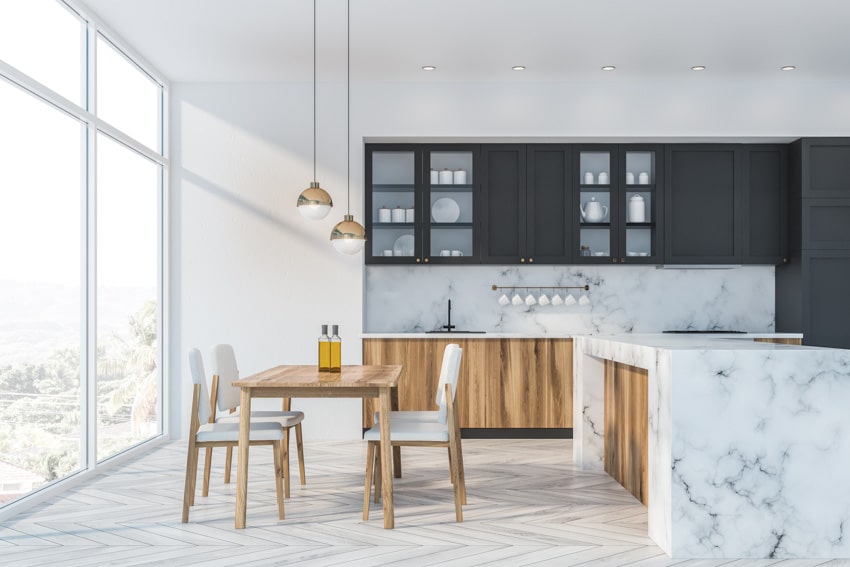 Kitchen with marble countertop, wooden dining set and floor to ceiling windows