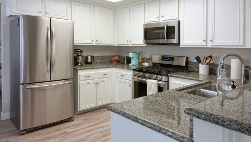 Kitchen with granite countertop and refrigerator