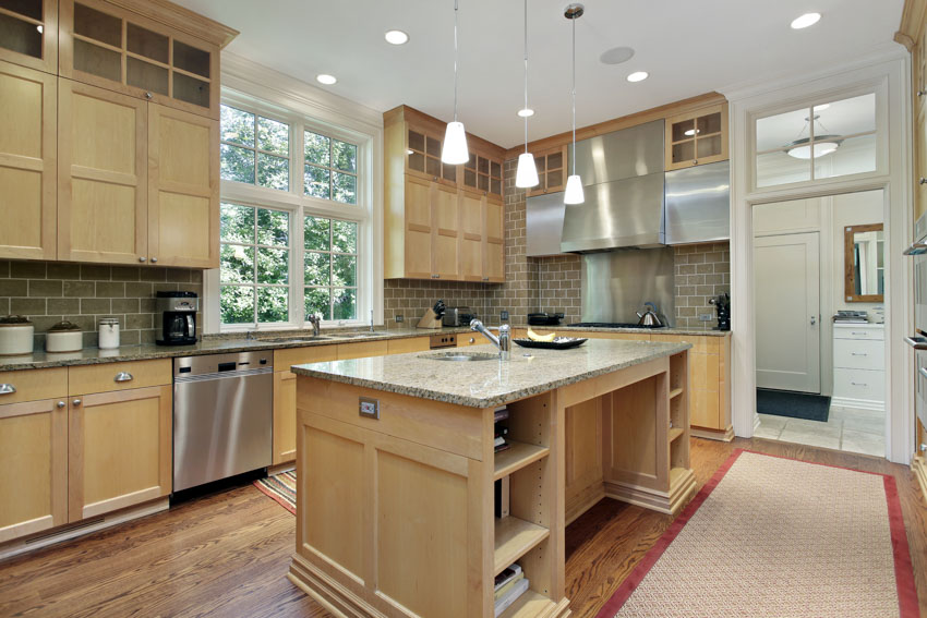 Gray countertops with tile backsplash and pendant lighting